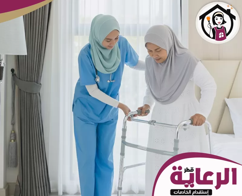 ممرضات منازل في قطر 051898847 مؤسسة الرعاية القطرية ممرضات منازل في قطر تساعد مسنّة في الانتقال من السرير إلى المقعد بأمان.